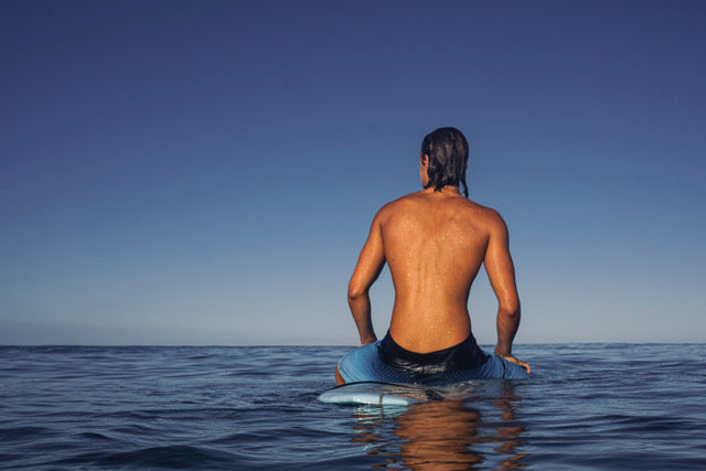 Surfer gazes at the sea